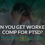 A person sitting holding his head to seek worker comp for PTSD