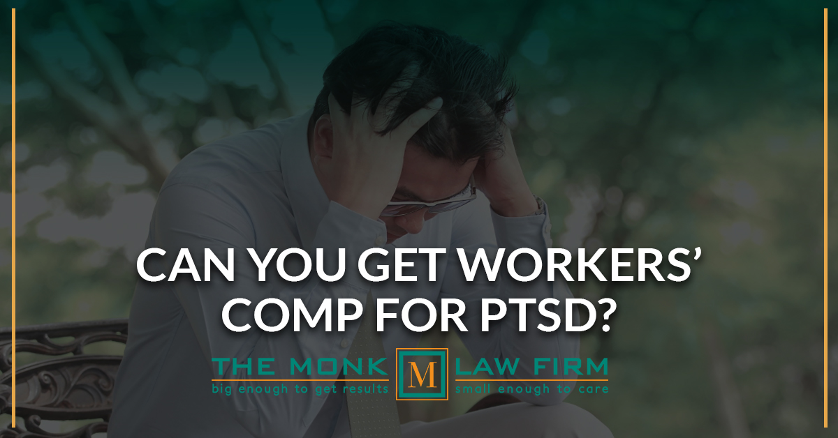 A person sitting holding his head to seek worker comp for PTSD